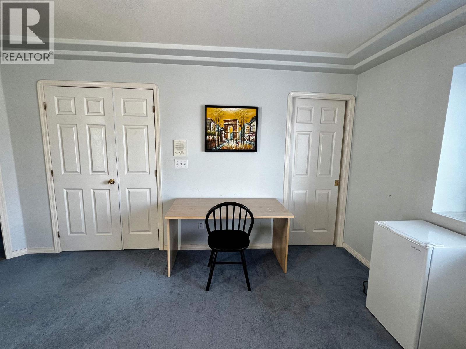 A room with a table and chair in it.