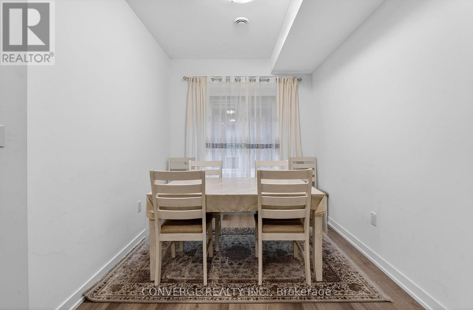 A dining room with a table and chairs.