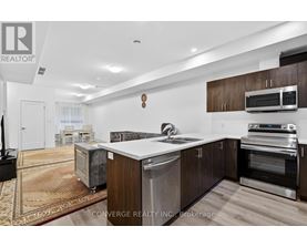 A modern kitchen with dark wood cabinets and stainless steel appliances.