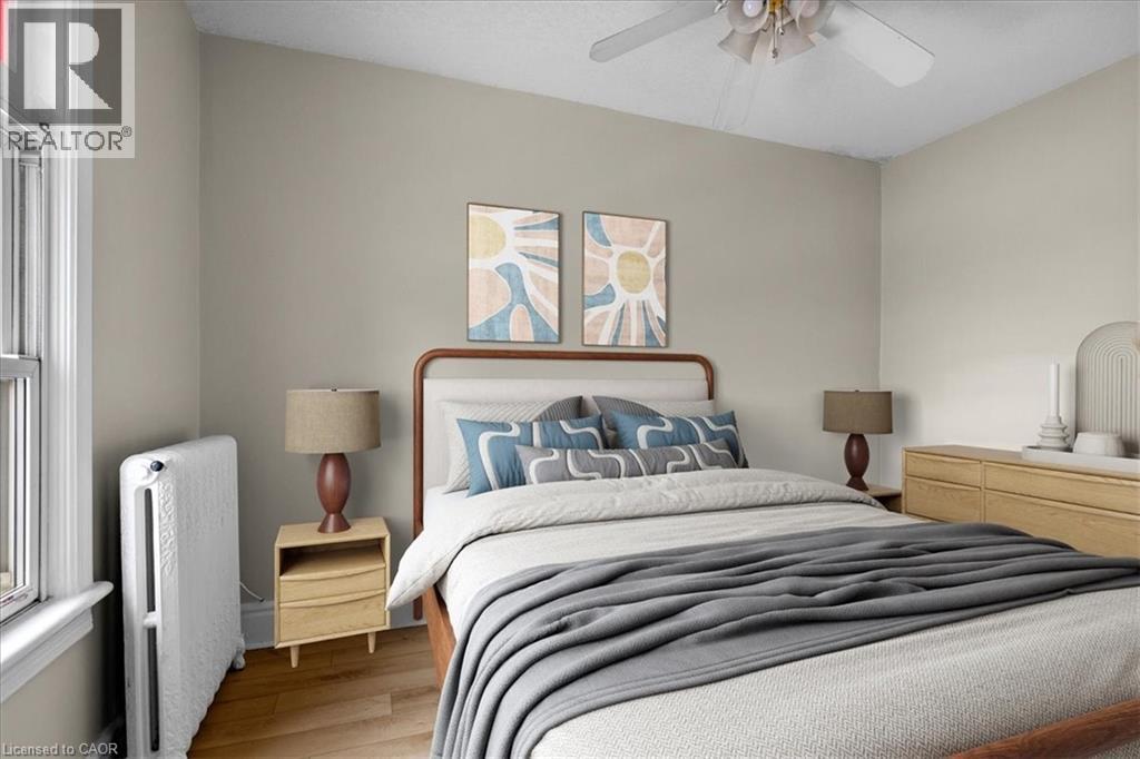 A bedroom with a large bed and a ceiling fan.
