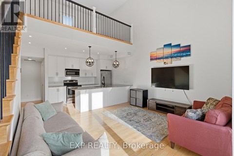 A living room with a grey couch and a pink couch.