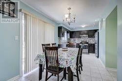 A dining room with a table set for six.