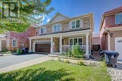 A house with a red brick exterior and a white garage door.