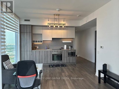 A modern kitchen with a dining table and chairs.