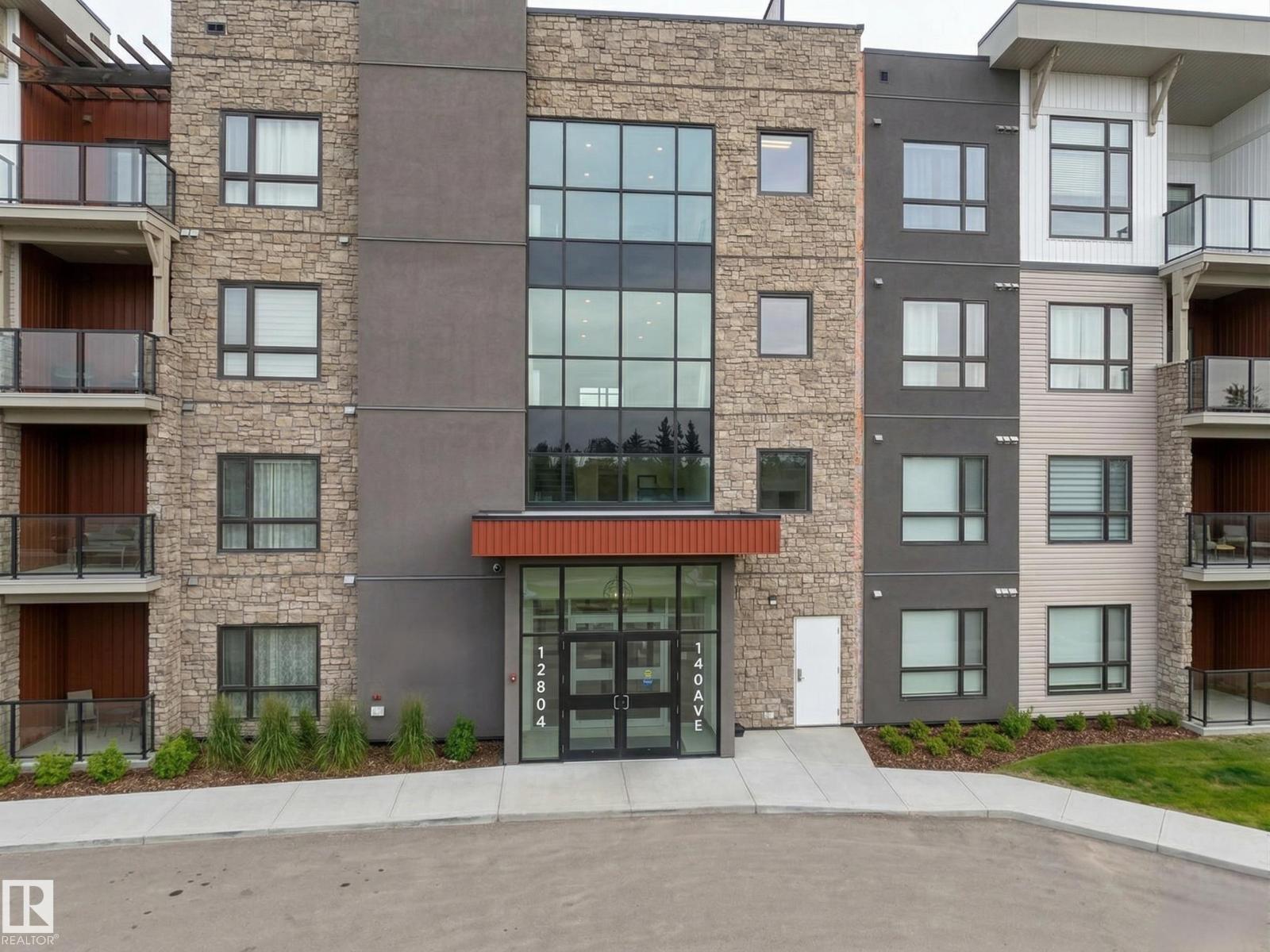 A modern apartment building with a mix of brick and panel construction.