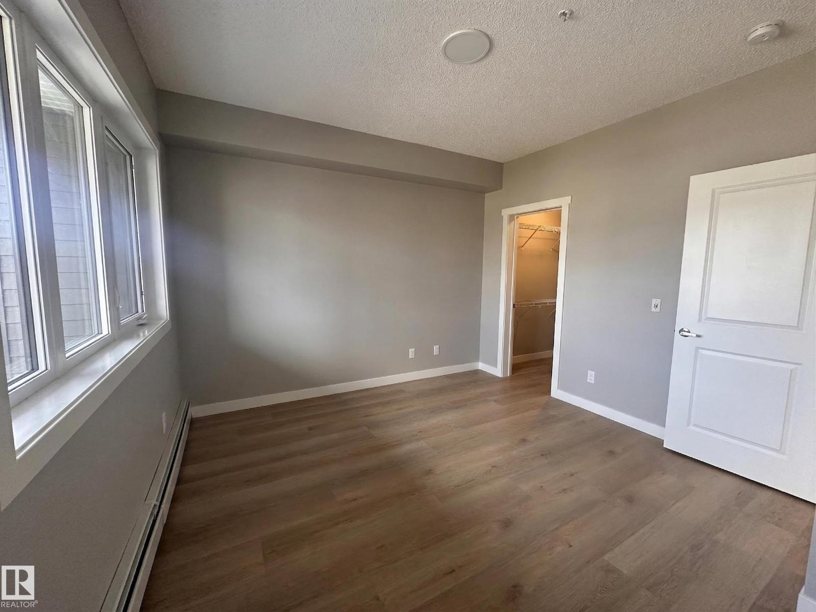 A room with wooden floors and white walls.