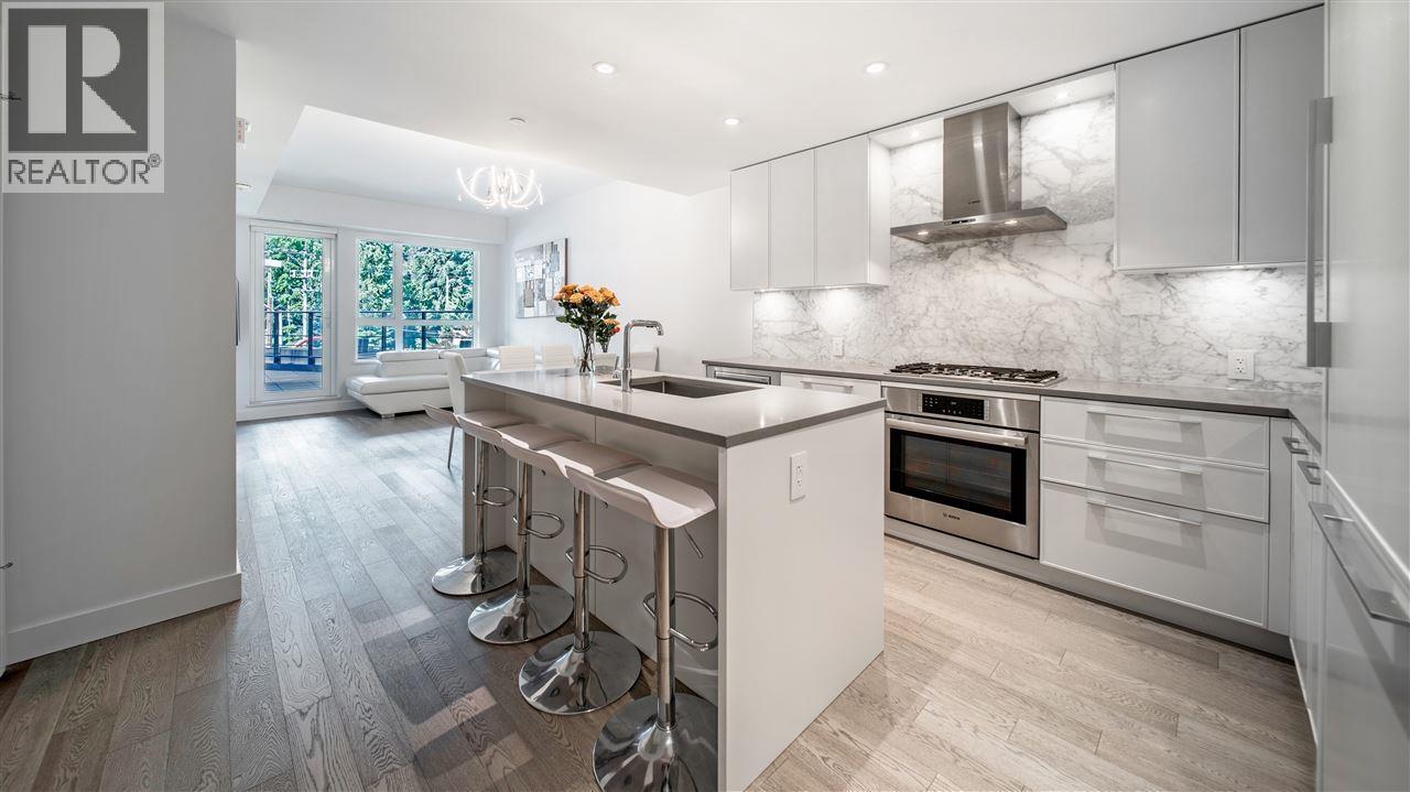 A modern kitchen with a bar area and a view of the backyard.