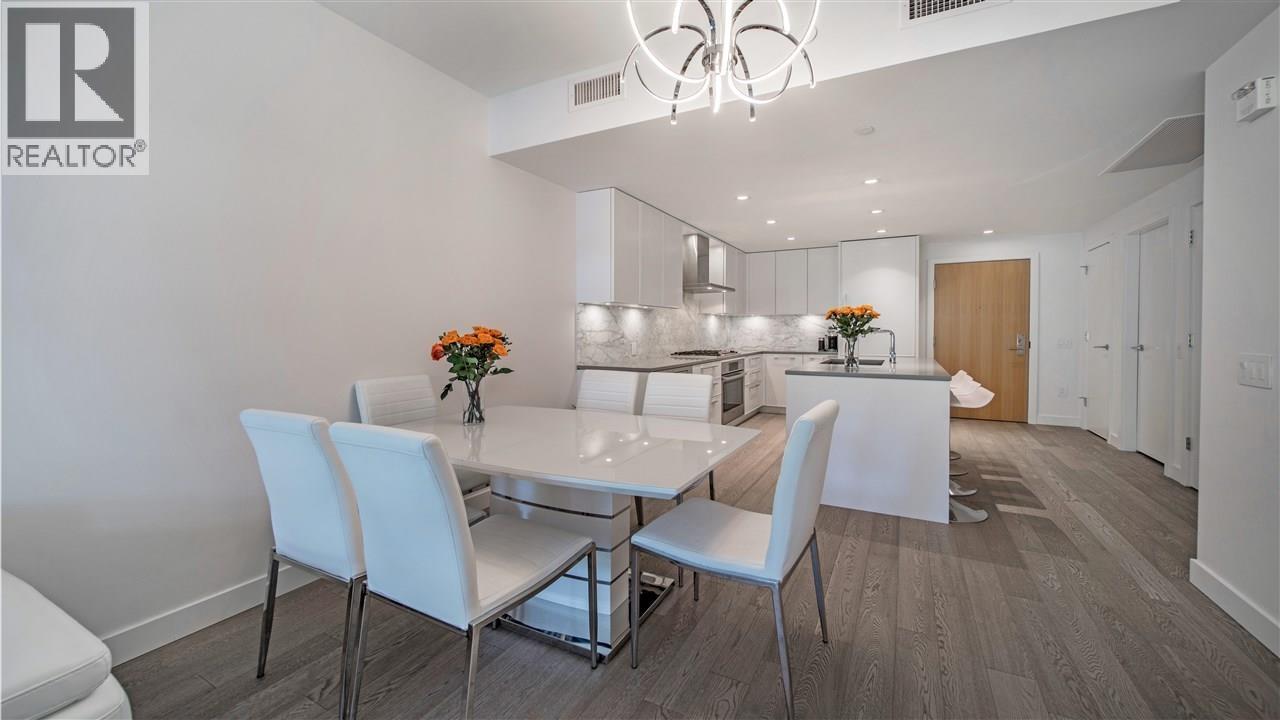 A dining room with a table and chairs.