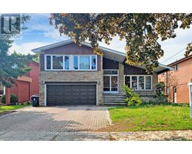 A two-story house with a garage and a driveway.