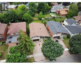 A bird's eye view of a residential neighborhood with houses and trees.