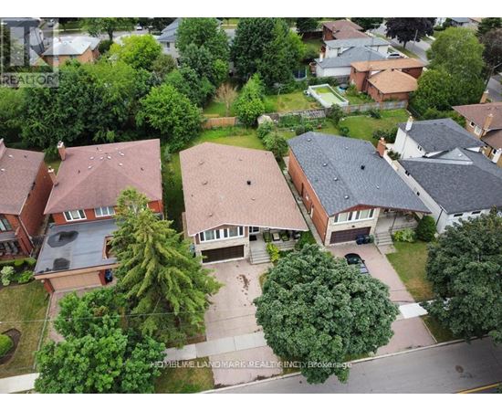 A bird's eye view of a residential neighborhood with houses and trees.