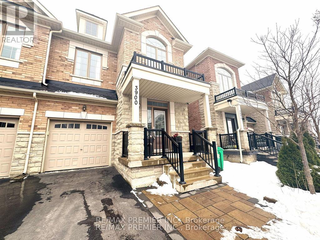 A house with a garage and a driveway in front.
