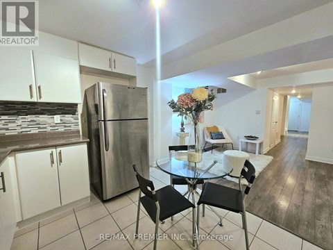 A kitchen with a table and chairs in the middle of the room.