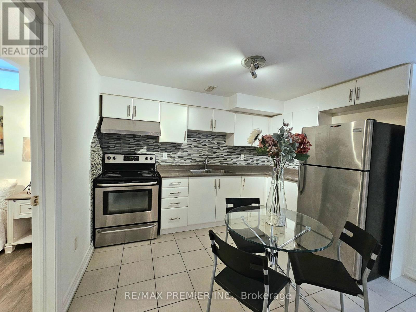 A kitchen with a glass table and chairs.