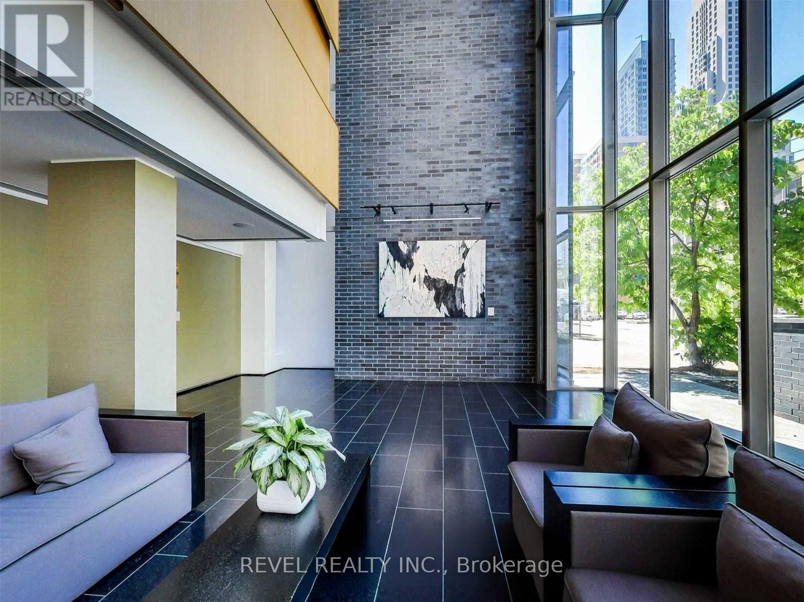 A modern living room with a brick wall and a large window.