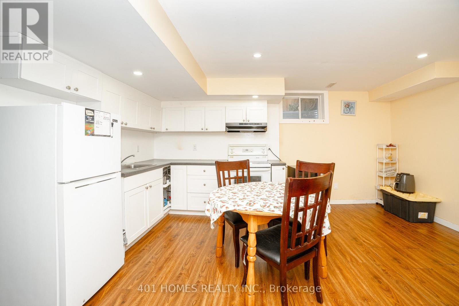 A kitchen with a table and chairs in the middle of the room.
