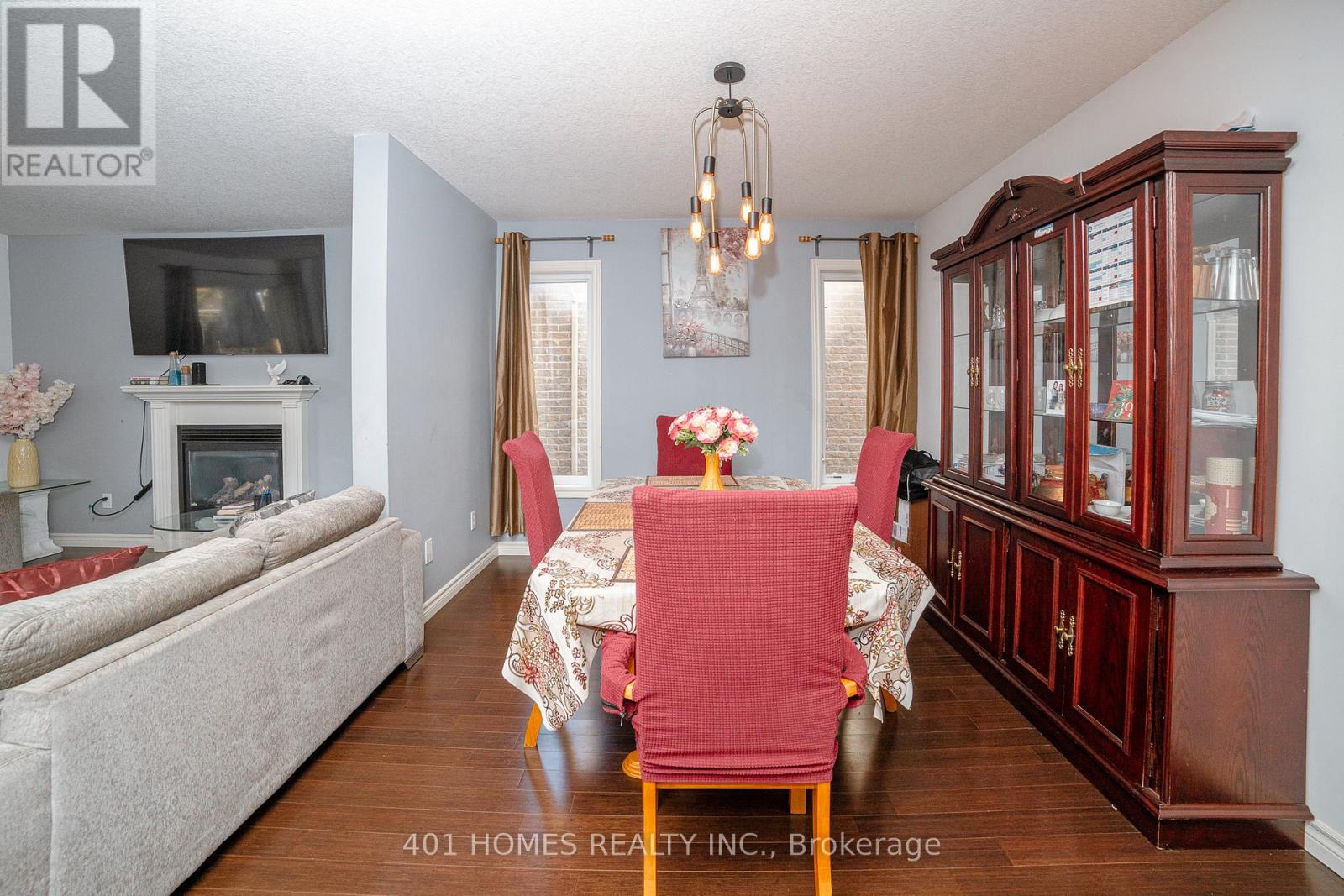 A dining room with a wooden table and chairs.