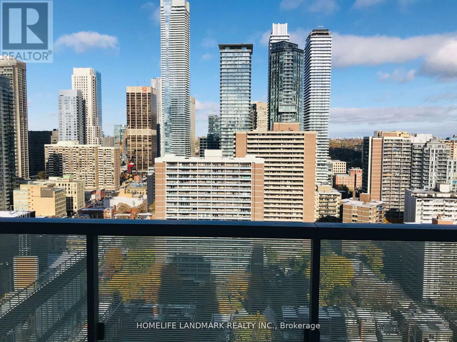 A cityscape with skyscrapers and a sign for HomeLife Landmark Realty Inc. Brokerage.