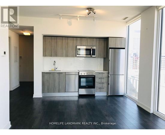 A kitchen with a stainless steel refrigerator, oven, and microwave.