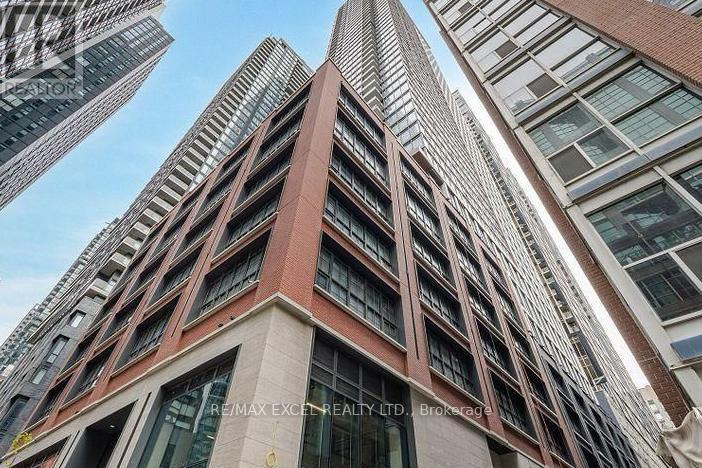 A tall building with a sign that reads "RE/MAX EXCELLENCE REALTY LTD. Brokerage".