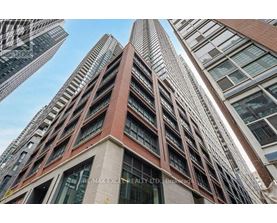 A tall building with a sign that reads "RE/MAX EXCELLENCE REALTY LTD. Brokerage".