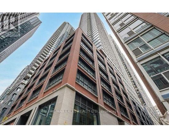 A tall building with a sign that reads "RE/MAX EXCELLENCE REALTY LTD. Brokerage".