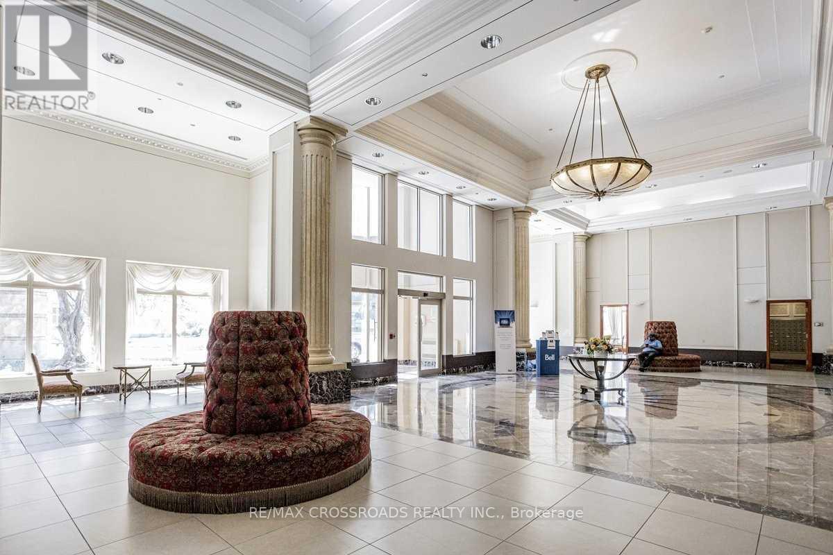 A large, elegant room with a round table and chairs in the center.