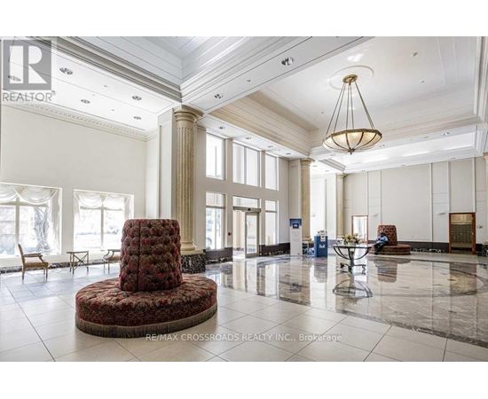 A large, elegant room with a round table and chairs in the center.