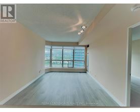 A spacious room with a large window overlooking a cityscape.