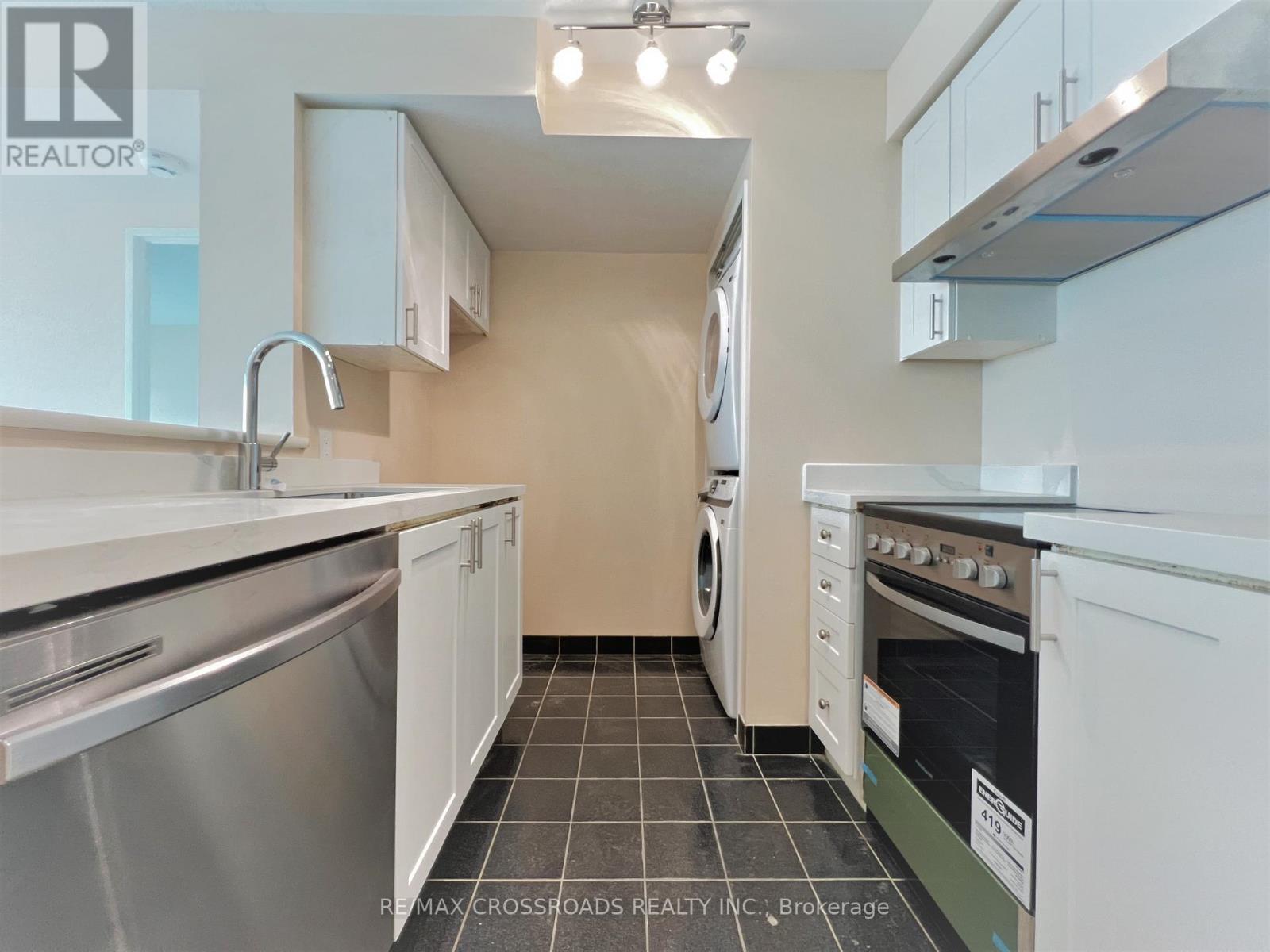 A kitchen with white cabinets and stainless steel appliances.