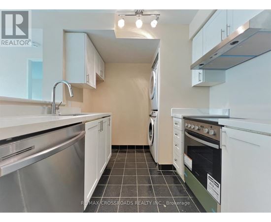A kitchen with white cabinets and stainless steel appliances.