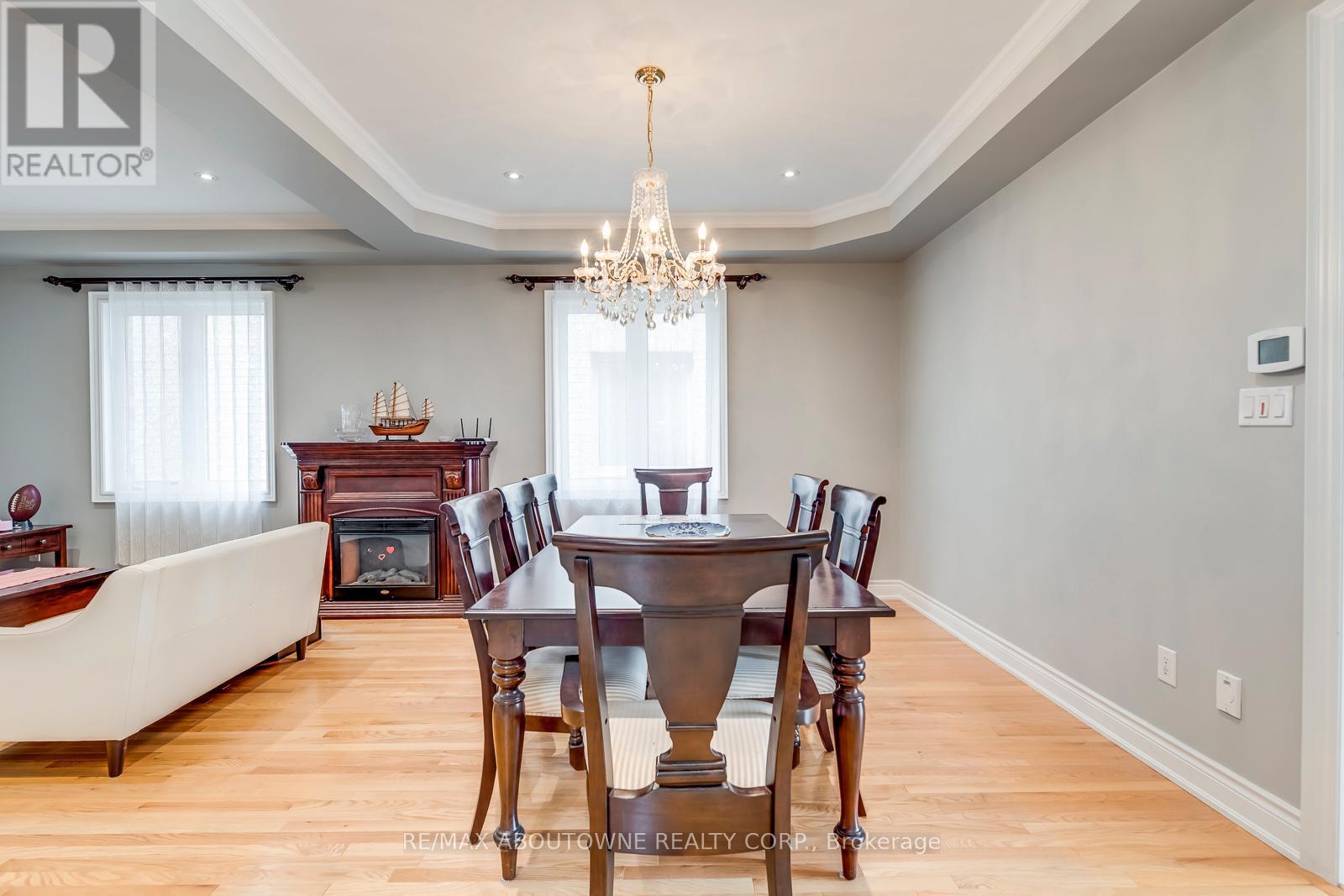 A dining room with a wooden table and chairs.