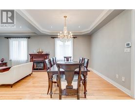 A dining room with a wooden table and chairs.