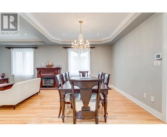 A dining room with a wooden table and chairs.
