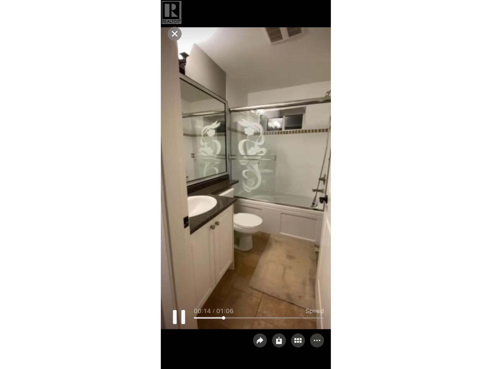 A bathroom with a toilet, sink, and shower.