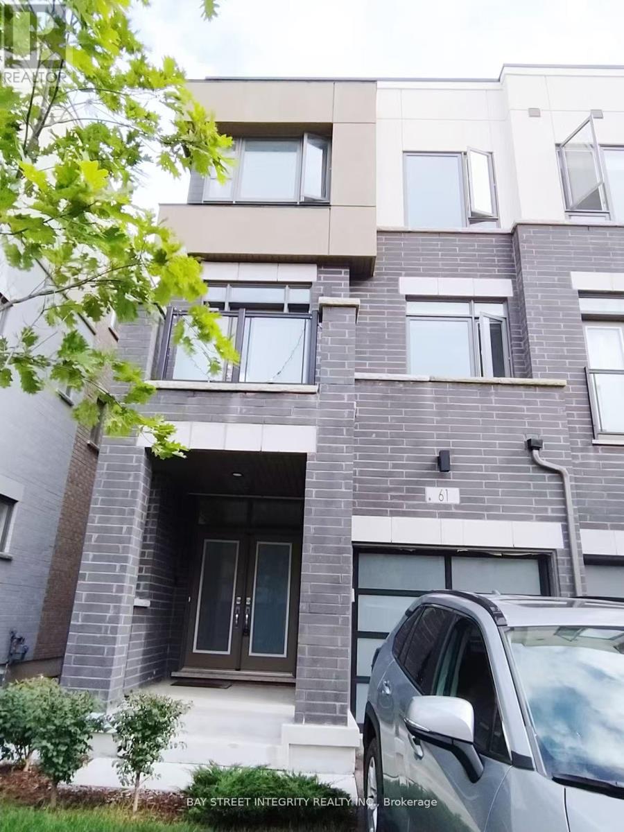 A grey building with a tree in front of it.