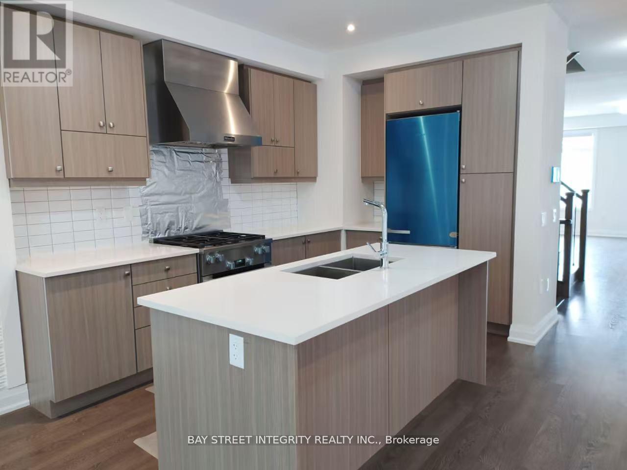 A kitchen with a white counter top and wooden cabinets.