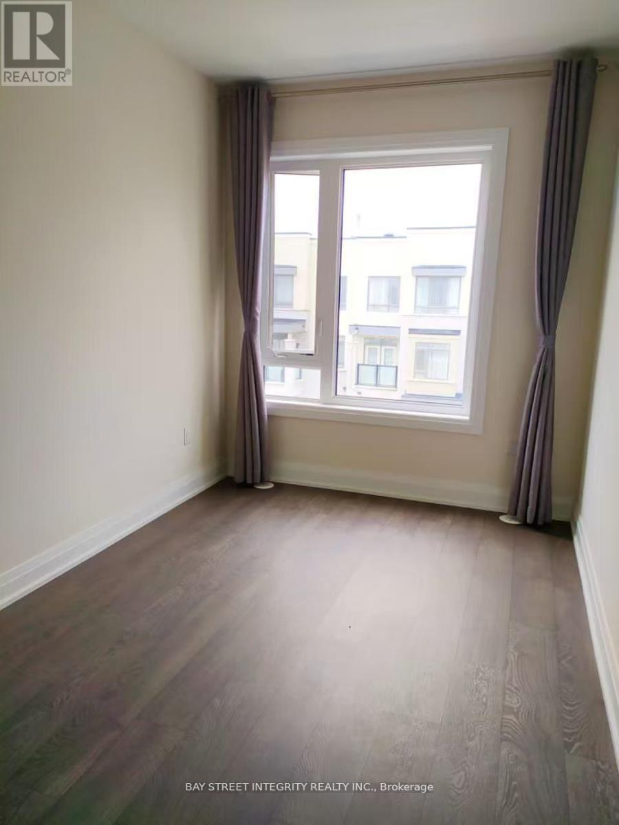 A room with a large window and curtains.