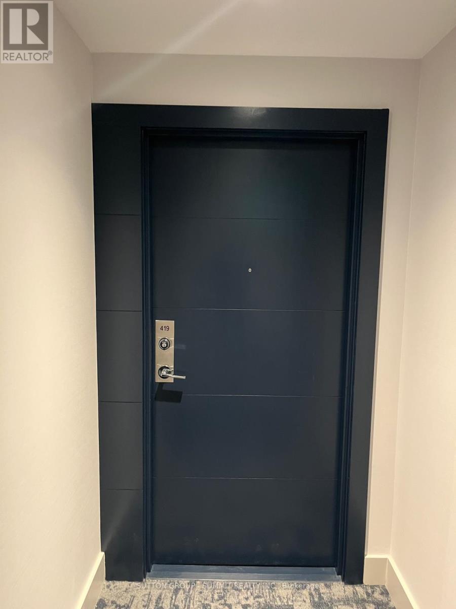 A black door with a silver handle and a keypad on the right side.
