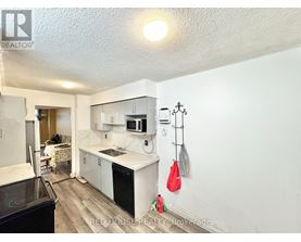 A kitchen with white cabinets and a black stove top oven.