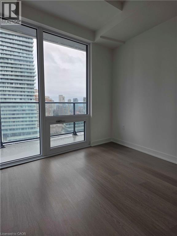 A room with a large window and a wooden floor.