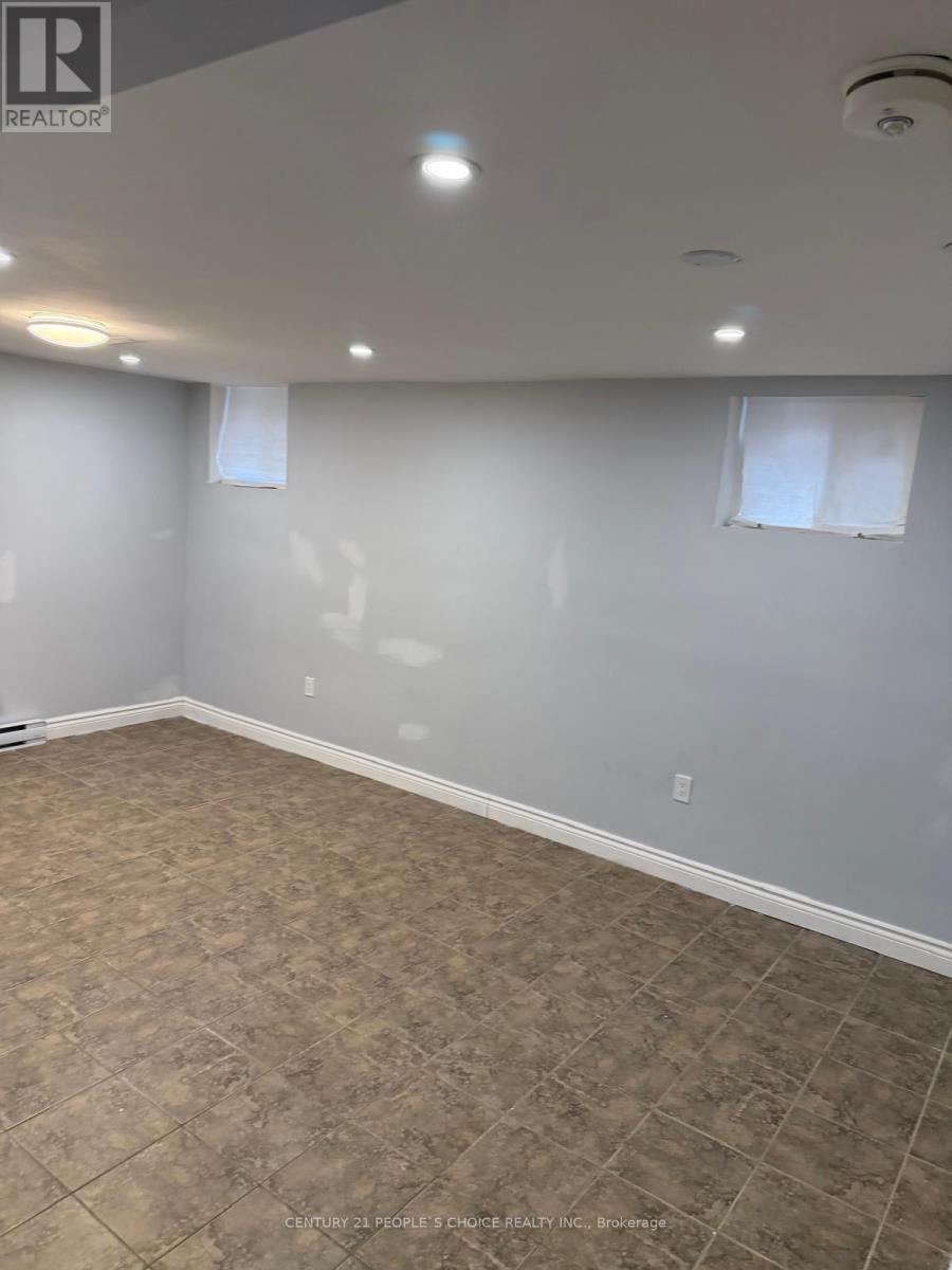 A room with a tiled floor and a window with blinds.