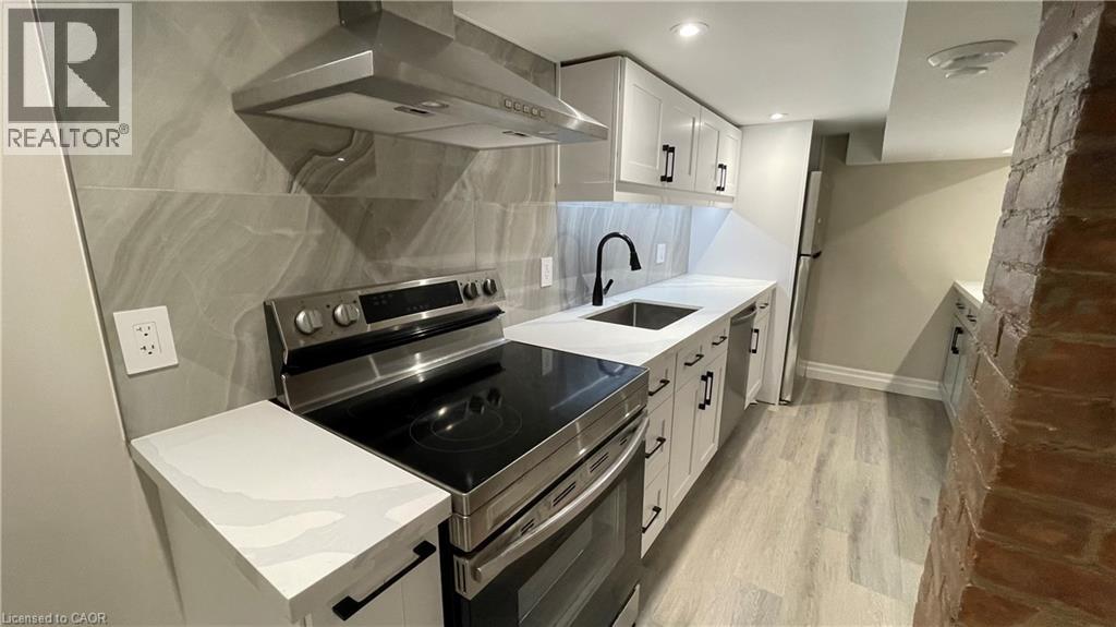 A modern kitchen with a stove top oven and a range hood.