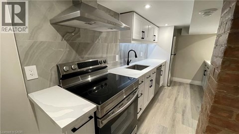 A modern kitchen with a stove top oven and a range hood.