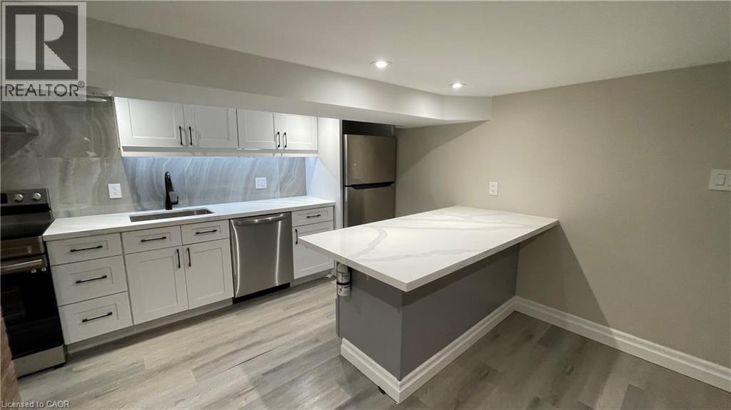 A well-lit kitchen with a large island in the middle.