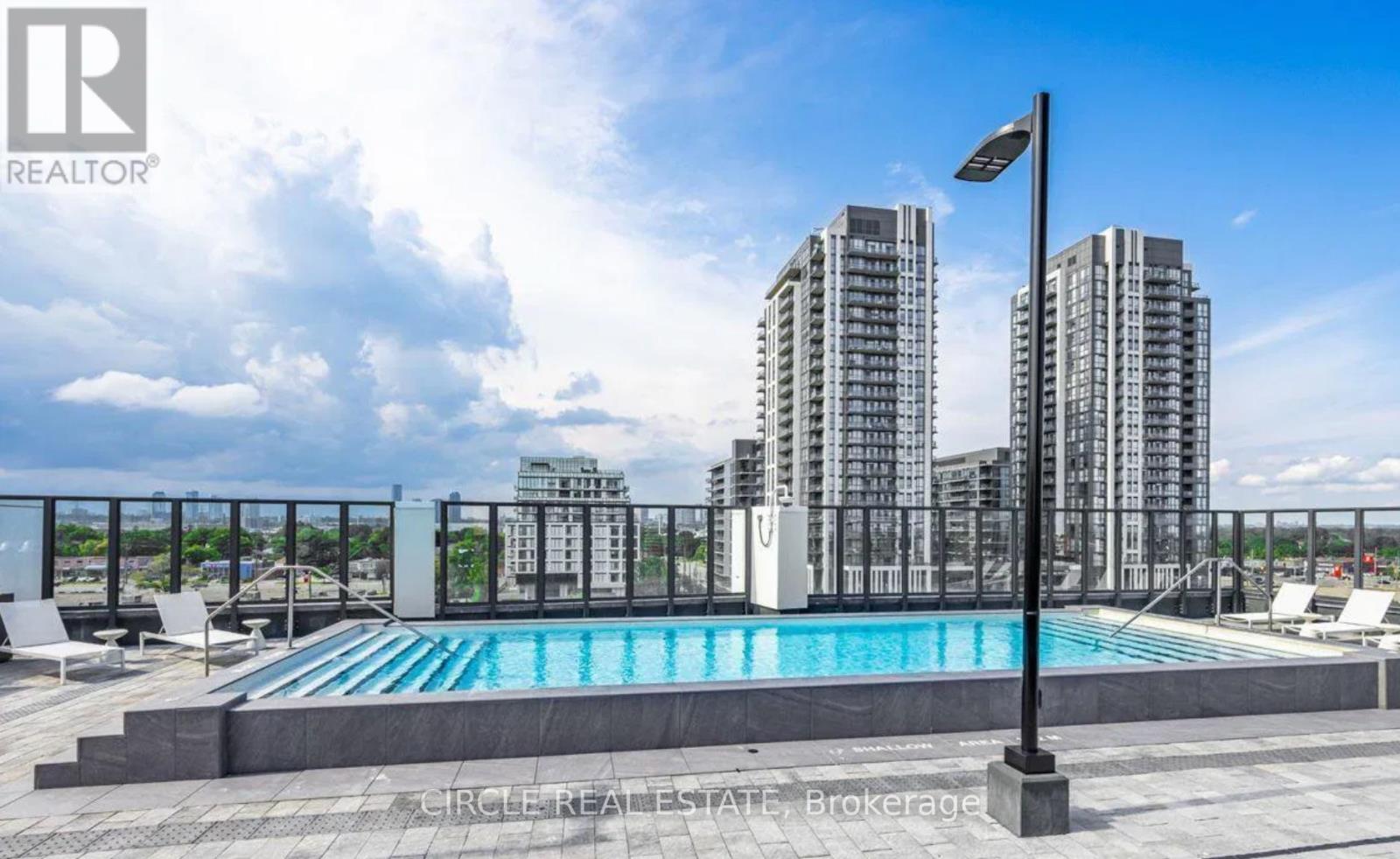A pool area with a view of apartment buildings.