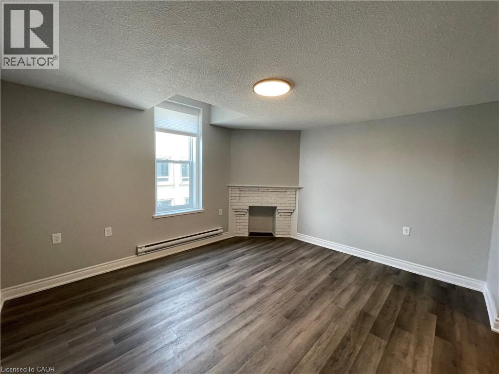 A room with a fireplace and a window.
