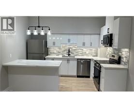 A modern kitchen with a large island and stainless steel appliances.