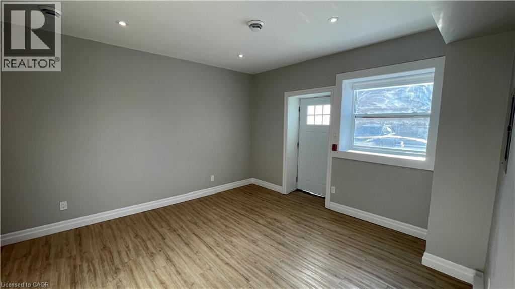 A room with a window and a door is available for rent.