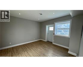 A room with a window and a door is available for rent.